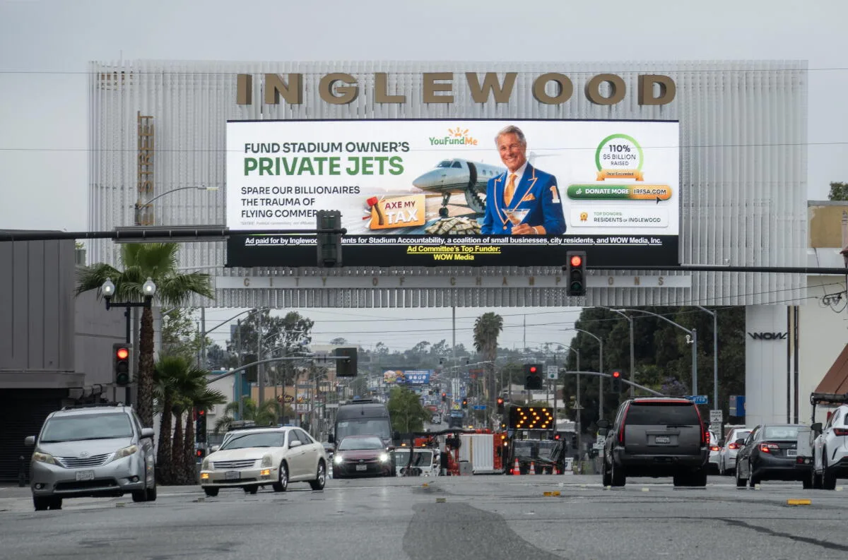 Street view of an Inglewood billboard: a “YouFundMe” parody ad reading “Fund stadium owner's private jets” and “spare our billionaires the trauma of flying commercial”